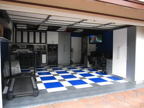 custom garage custom cabinets custom home office modern closet factory Completed garage with custom cabinetry, flooring, a safe and a built in desk.