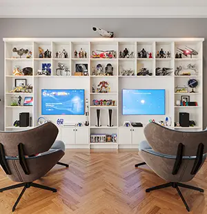 Custom media wall with open shelving for collectibles, dual mounted screens