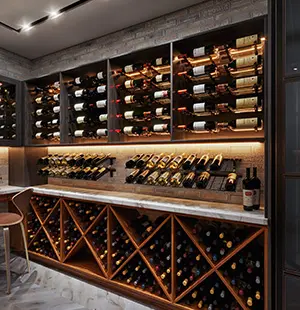 Custom wine room with open bottle displays, marble countertop, and under-cabinet lighting