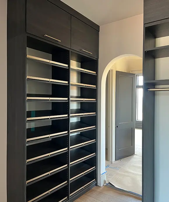 Custom walk in closet shelving with display shoe shelving in black