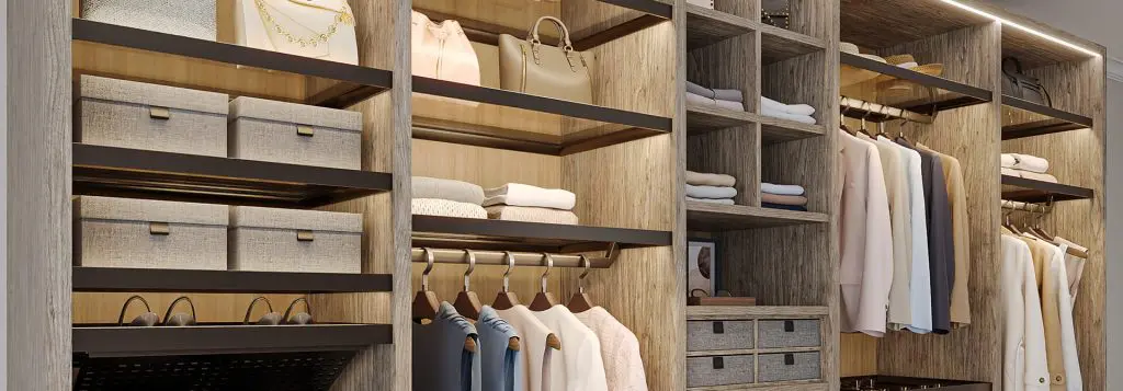 Modern custom closet in Mohave County featuring warm wood textures, LED-lit shelving, hanging space for clothing