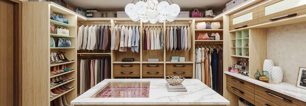 Custom walk in closet in light woodgrain melamine with center island