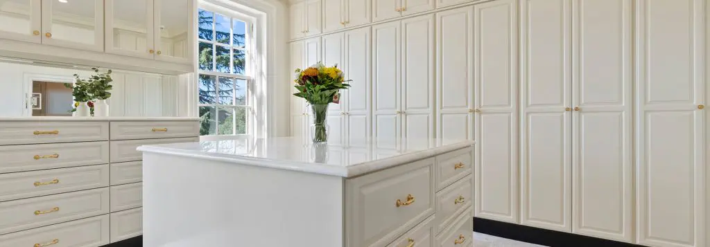 Closet Factory Richmond walk in closet with shaker white cabinetry and center island