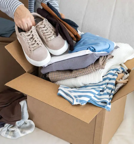 clothes being packed inside a shipping box