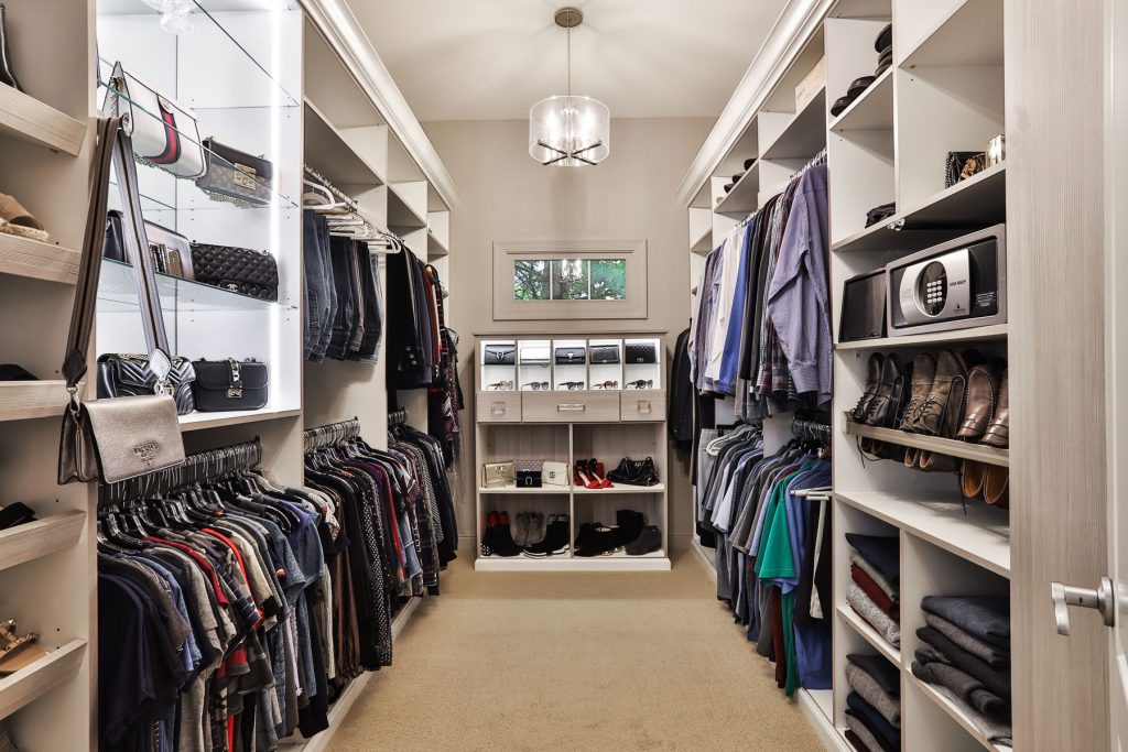 custom walk in closet with a sunglass storage system