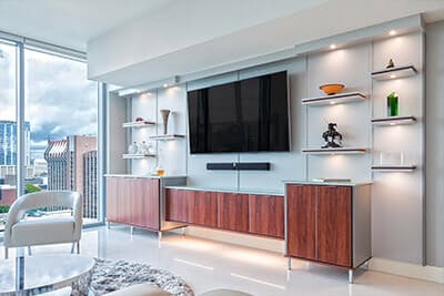 Flat screen tv floats above base cabinets.