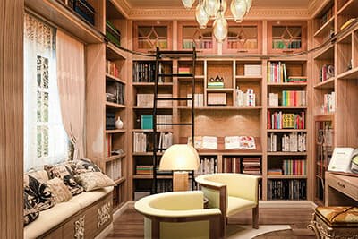 Bedroom converted into a home library with floor to ceiling shelving.