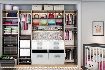 Cute kid room has reach-in closet system that has built-in titling hampers, cubbies for baby hats, nursery area has a built-in changing table.