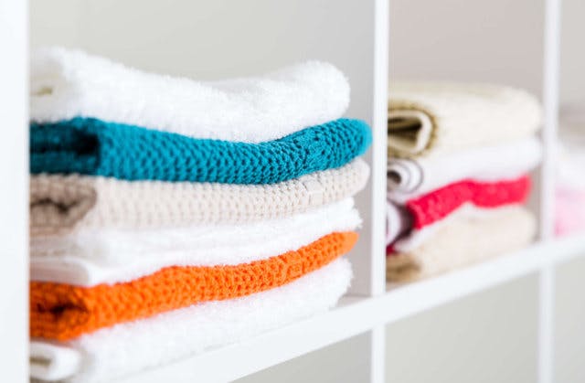 ugly sweaters on shelves that should be tossed