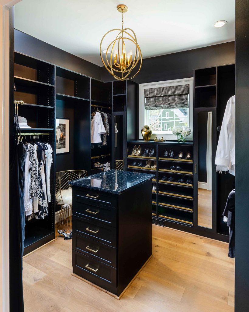 black closet system for walk-in closet with an island.