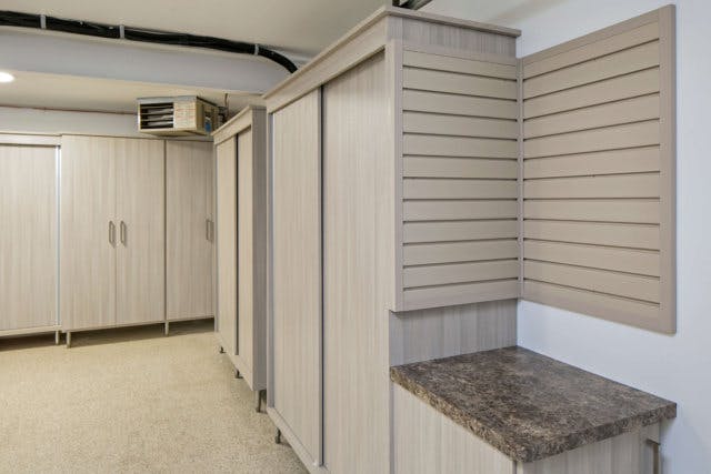 A garage full of cabinets and a heater unit