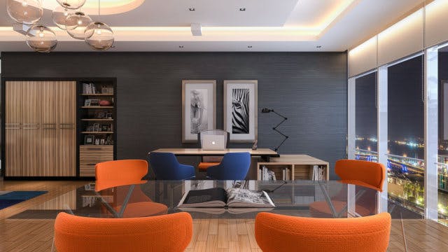 A mid-century styled office with blue and orange chairs