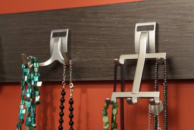 A two-pronged jewelry hook and a five-pronged jewelry hook show different ways to organize jewelry