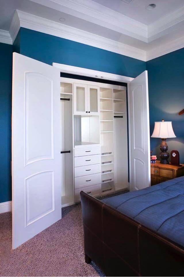 A white closet unit installed in a bedroom closet