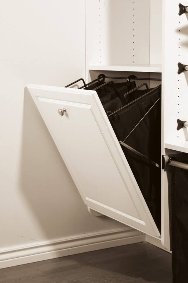 A tip-out laundry hamper. When stored, it appears as just another cabinet door