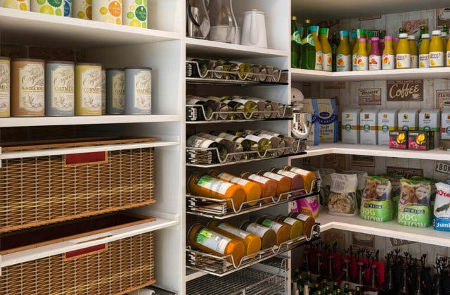A well organized pantry with numerous spice racks