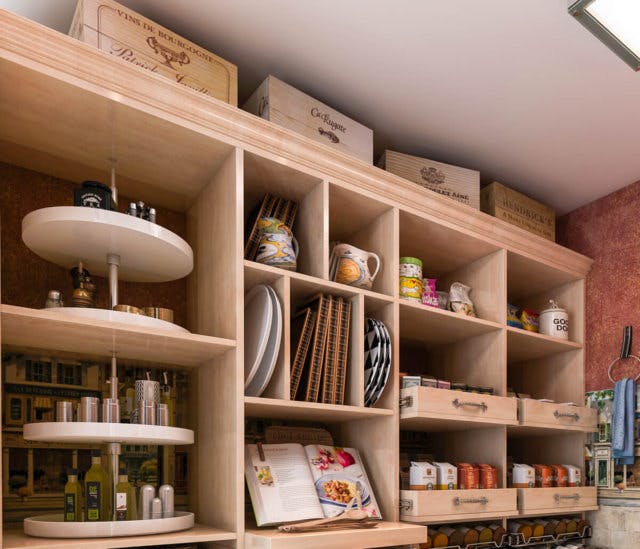 A custom kitchen pantry with built-in spinning spice racks