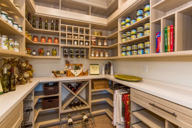 A wide open pantry complete with wine storage and cook books