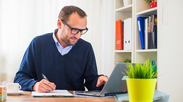 man at computer working in home office
