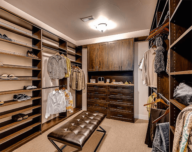 A dark wood walk-in with a leather bench