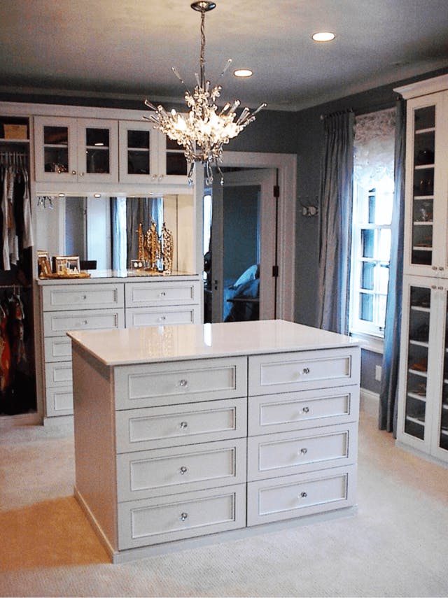 A white and slate grey closet with central island