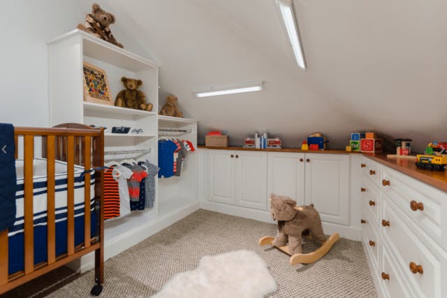 A kids room with countertops all the way around