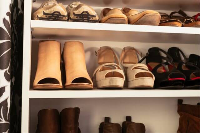 shoes lined up on a flat shelf