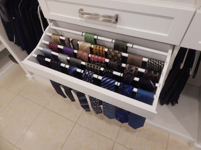 A pull-out tie rack allows for easy organization of many ties