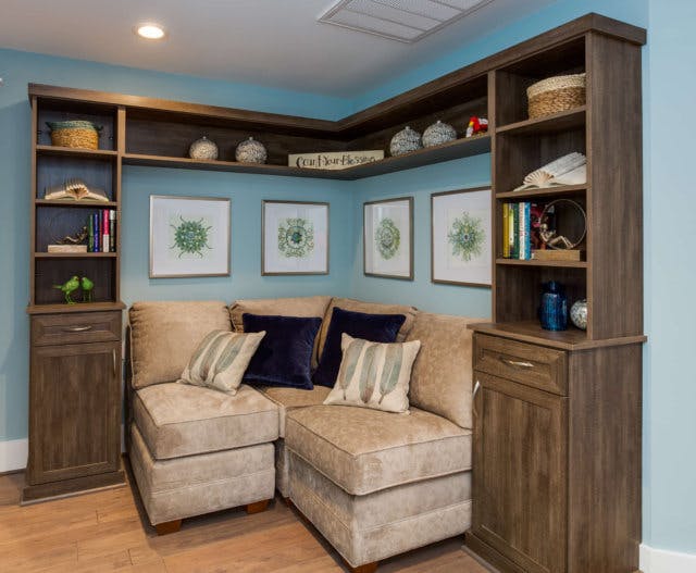 Custom built corner cabinetry over a corner couch