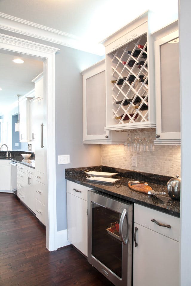 Bar wall unit for wine storage and kitchen overflow.