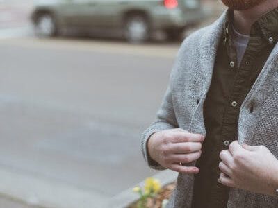 person holding jacket while on