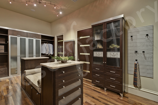 A large walk-in closet, complete with central bench and island