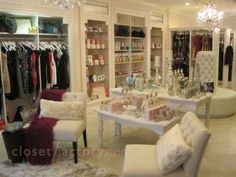 A large walk-in closet, complete with boutique seating