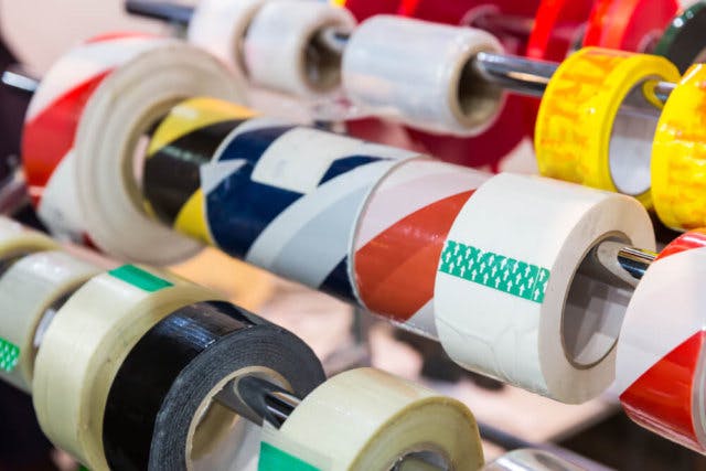 A set of tape rolls on rods