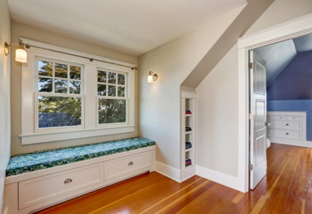 A second-story room with a window bench