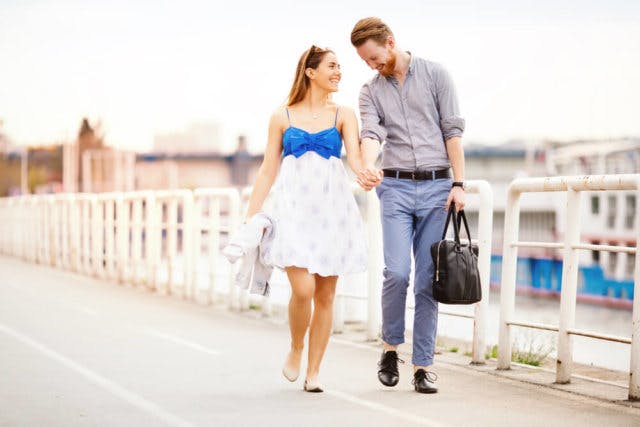 A young couple walking down the street