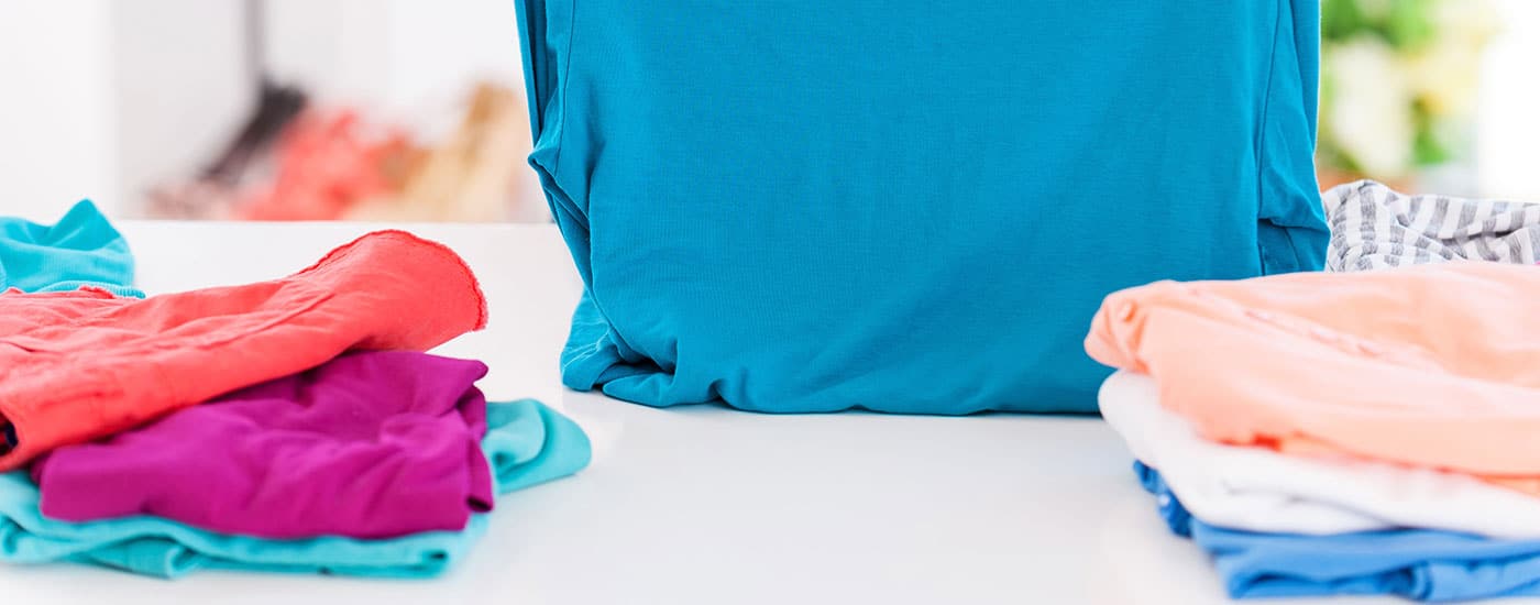 laundry room counter with folded clothing