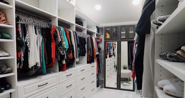 white custom closet with mirrored cabinet doors