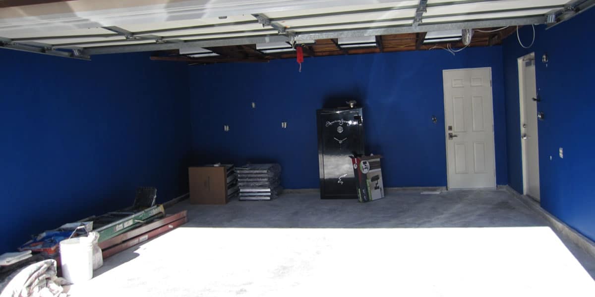 empty garage painteed blue and ready for new cabinetry 