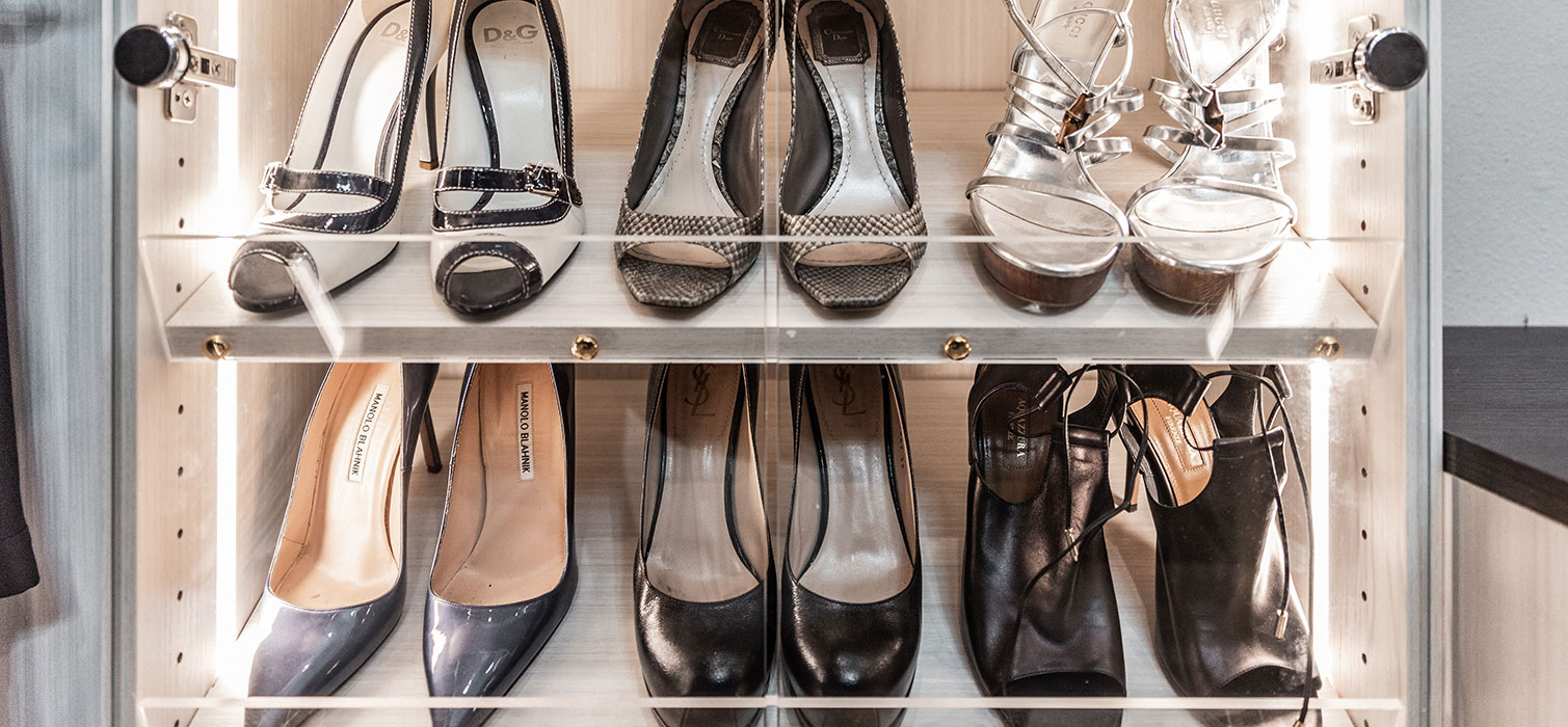 pairs of shoes organized flat on shelves