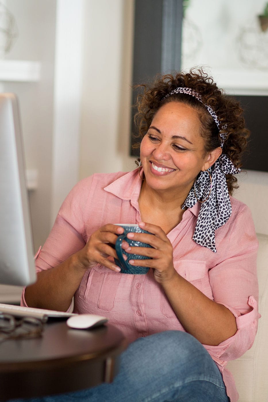 office woman drinks coffee at her desk