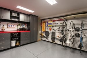 A garage with grey cabinets and wall hung storage