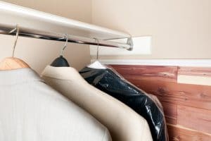 Suit jackets in a closet with a cedar wall