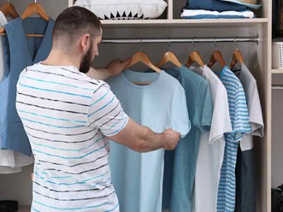 Man organizing closet