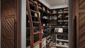 A brown wood pantry with a rolling ladder