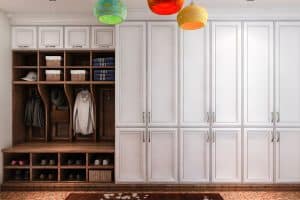 Large white cabinets and a wood mud room