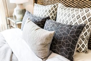 Geometric decorative pillows on a bed