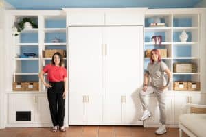 The Go 2 Girls stand next to their wallbed