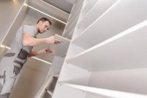 A handyman installs a closet