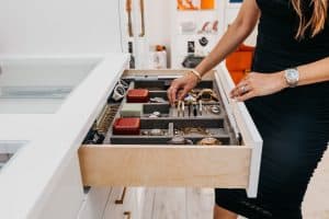 A woman opening a jewelry drawer
